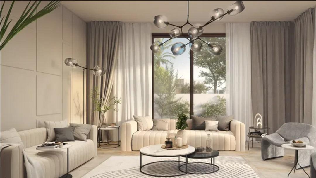 Spacious open plan living room inside a Fay Alreeman, with floor-to-ceiling windows and premium finishes
